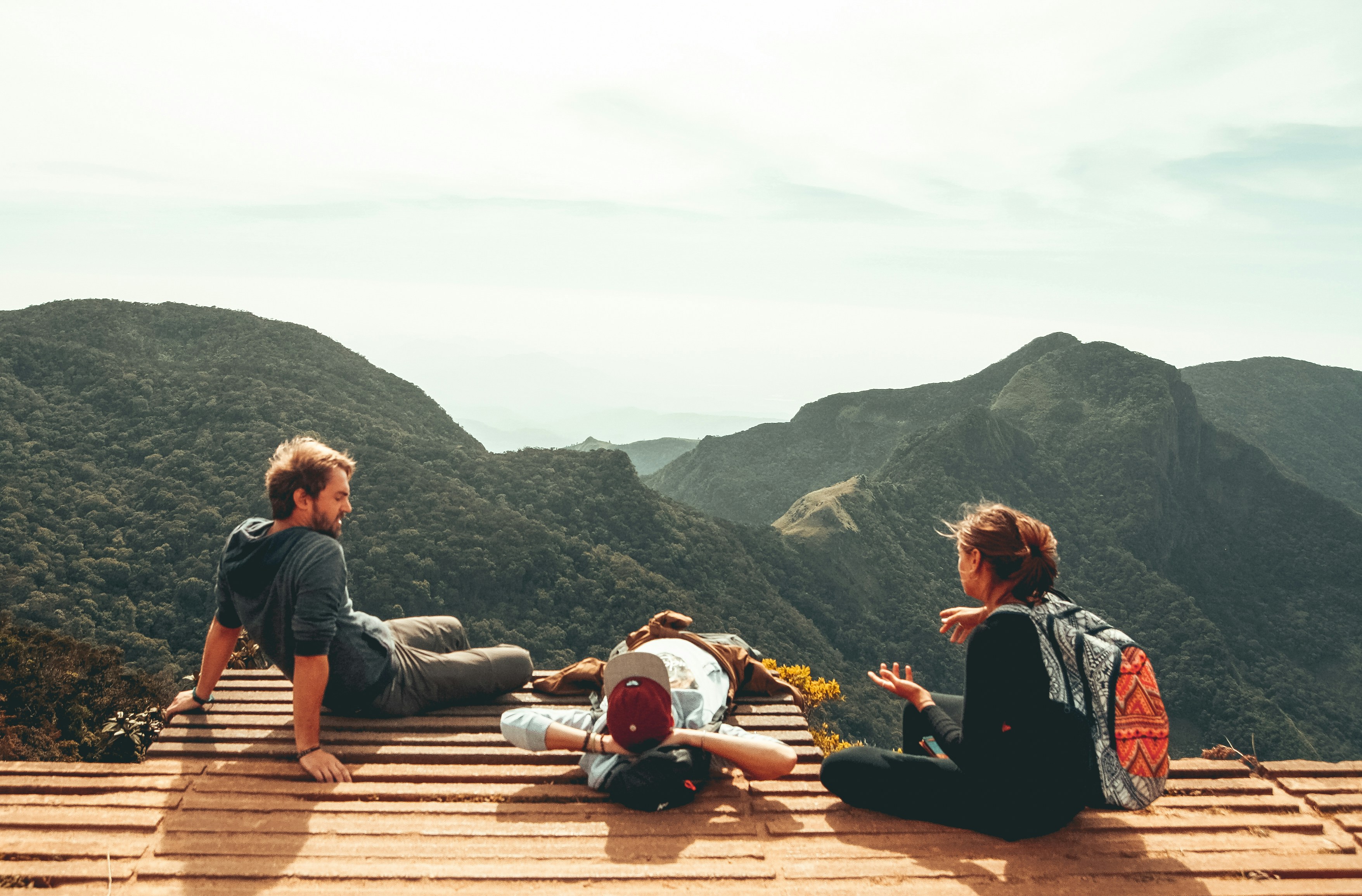 Independent professionals relaxing on a mountain overlook